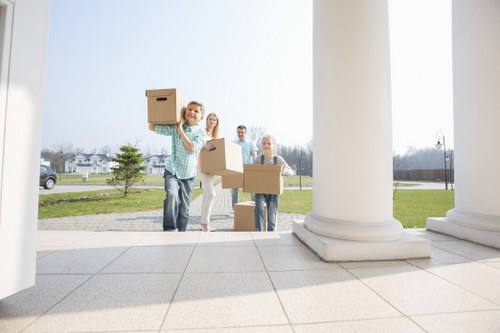 Professional movers carrying boxes for a central London flat move