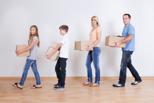 Moving professionals loading business furniture in a busy central London area